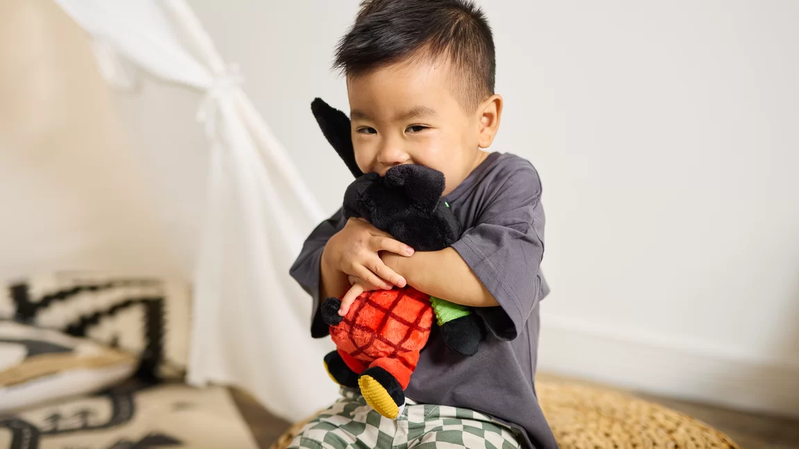 Boy hugging Bing toy