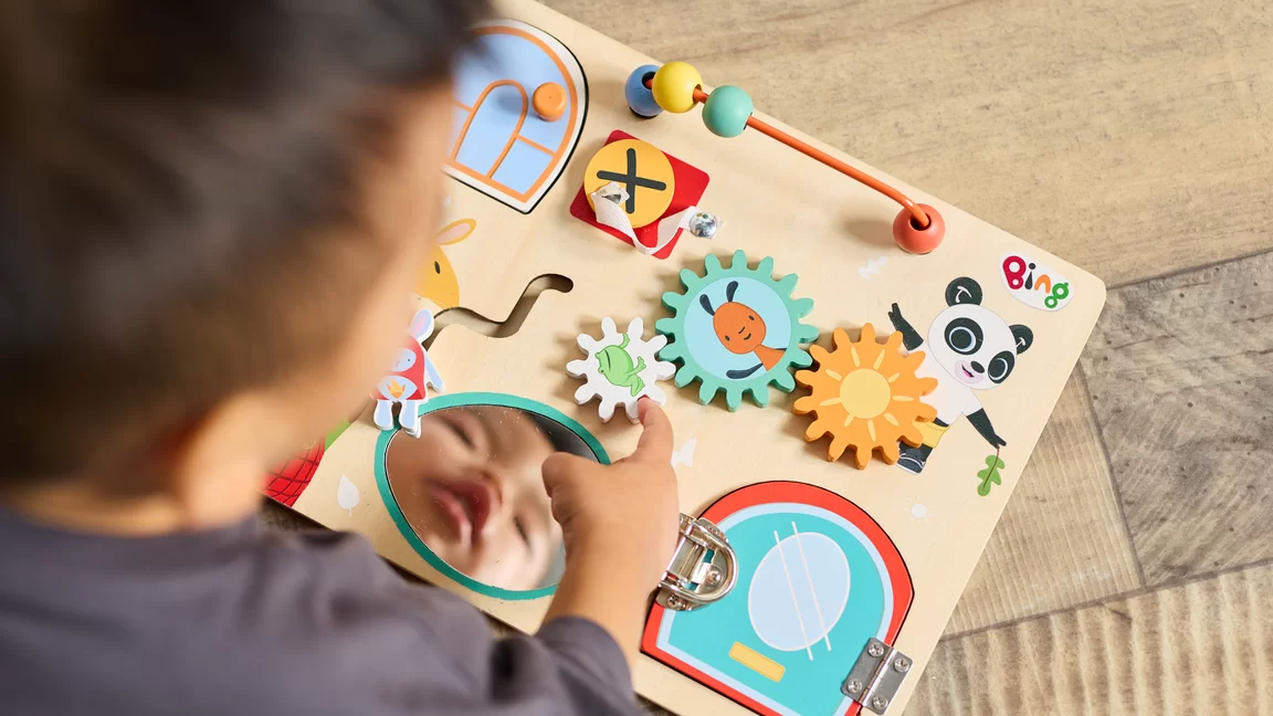 Overhead photo of child playing with Bing puzzle game