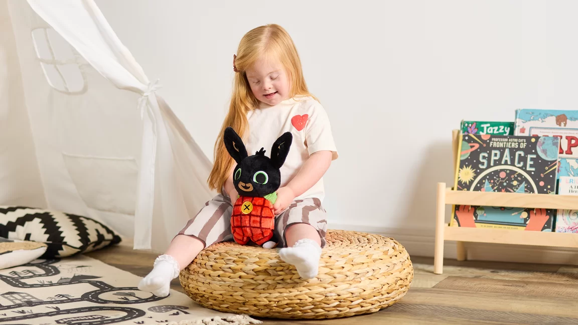 Young girl playing with Bing plush
