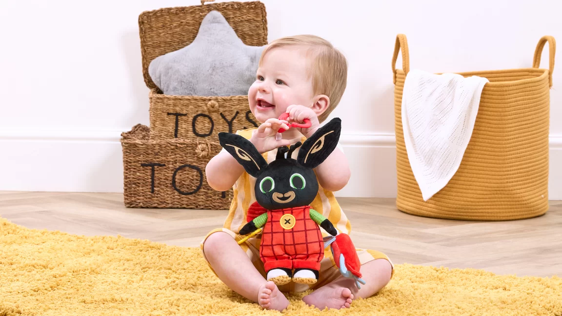 baby holding bing plush