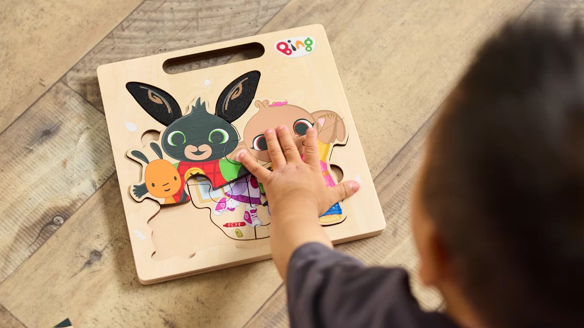 Overhead image of child playing with Bing Puzzle 